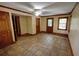 Spacious bedroom with tiled floors, trim, ceiling fan, and a back door leading to the backyard at 4393 Cannon Rd, Loganville, GA 30052