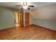 A charming bedroom features a closet, an open doorway, hardwood floors, and neutral-colored walls at 4393 Cannon Rd, Loganville, GA 30052
