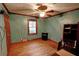 Bedroom with beautiful wood trim and floors, a ceiling fan, and a window for ample natural light at 4393 Cannon Rd, Loganville, GA 30052