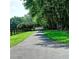 Long driveway leads to gated property surrounded by lush greenery and mature trees at 4393 Cannon Rd, Loganville, GA 30052