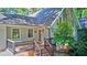 Home with an inviting entrance featuring a stone chimney and covered front porch and wood staircase at 4393 Cannon Rd, Loganville, GA 30052