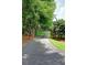 Gated entrance to a sprawling estate with mature trees and long driveway leading to the property at 4393 Cannon Rd, Loganville, GA 30052
