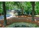 Traditional home with attached garage nestled amongst mature trees and lush landscaping at 4393 Cannon Rd, Loganville, GA 30052