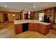 Well-lit, classic kitchen features a breakfast bar and seamlessly connects to the adjacent living areas at 4393 Cannon Rd, Loganville, GA 30052