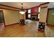 The open living room showcases wood floors, a stone fireplace, and abundant natural light at 4393 Cannon Rd, Loganville, GA 30052