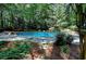 Beautiful backyard pool surrounded by lush greenery, creating a private oasis for relaxation and entertainment at 4393 Cannon Rd, Loganville, GA 30052