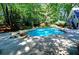 Beautiful backyard pool surrounded by lush greenery, creating a private oasis for relaxation and entertainment at 4393 Cannon Rd, Loganville, GA 30052