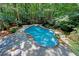 Beautiful backyard pool surrounded by lush greenery, creating a private oasis for relaxation and entertainment at 4393 Cannon Rd, Loganville, GA 30052