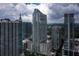 Stunning aerial view of a modern high-rise with city views and beautiful blue skies with white fluffy clouds at 855 Peachtree Ne St # 3304, Atlanta, GA 30308