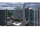 An eye-level aerial view of a modern high-rise with city views and beautiful blue skies with white fluffy clouds at 855 Peachtree Ne St # 3304, Atlanta, GA 30308