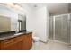 Bathroom with single sink vanity, granite countertop, tiled floors, and enclosed glass shower at 855 Peachtree Ne St # 3304, Atlanta, GA 30308