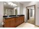 Modern bathroom featuring a double vanity, granite countertops, tiled flooring, and a walk-in shower at 855 Peachtree Ne St # 3304, Atlanta, GA 30308