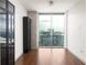Bright bedroom featuring hardwood floors, black cabinetry, and an impressive city view at 855 Peachtree Ne St # 3304, Atlanta, GA 30308