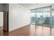 Inviting living room featuring hardwood floors and a large window showcasing the cityscape at 855 Peachtree Ne St # 3304, Atlanta, GA 30308