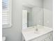 Bright bathroom featuring white vanity with a large mirror at 1010 Capella Creek Way, Grayson, GA 30017