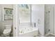 Bright bathroom with jacuzzi tub and glass shower at 1010 Capella Creek Way, Grayson, GA 30017