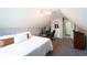 Bedroom with carpet and sloped ceiling features a bed and doorway at 1010 Capella Creek Way, Grayson, GA 30017