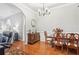 Dining room featuring hardwood flooring, classic furniture, and decorative lighting at 1010 Capella Creek Way, Grayson, GA 30017