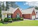 Beautiful brick home with manicured lawn, a two-car garage, and traditional architectural design at 1010 Capella Creek Way, Grayson, GA 30017