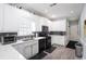 Modern kitchen with stainless appliances, white cabinets, and eat-in area at 1010 Capella Creek Way, Grayson, GA 30017