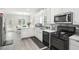Modern kitchen features sleek appliances, gray backsplash and an eat-in area at 1010 Capella Creek Way, Grayson, GA 30017