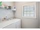 Laundry room features a window and a modern, white washer and dryer at 1010 Capella Creek Way, Grayson, GA 30017