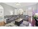 Comfortable living room featuring an archway, hardwood floors, and a sectional sofa at 1010 Capella Creek Way, Grayson, GA 30017