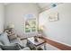 Bright living room boasts hardwood floors, a large window, and vaulted ceiling at 1010 Capella Creek Way, Grayson, GA 30017