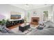 Comfortable living room features hardwood floors, a fireplace, and a sectional sofa at 1010 Capella Creek Way, Grayson, GA 30017
