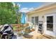 Outdoor wooden patio with dining table, grill, umbrella, and chairs perfect for relaxing and enjoying the weather at 1010 Capella Creek Way, Grayson, GA 30017