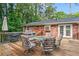 Inviting back deck features outdoor dining set, grill, and access to the home's interior at 2703 Carolyn Se Dr, Smyrna, GA 30080