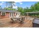 View of the wooden back deck with outdoor seating near a detached carport at 2703 Carolyn Se Dr, Smyrna, GA 30080