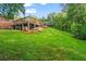 Spacious backyard featuring a deck, carport, and sloped lawn at 2703 Carolyn Se Dr, Smyrna, GA 30080