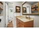 Bathroom with granite countertops, decorative mirror, and white toilet and sink at 2703 Carolyn Se Dr, Smyrna, GA 30080