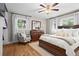 Comfortable bedroom with hardwood floors, natural light, dresser, and plush bedding at 2703 Carolyn Se Dr, Smyrna, GA 30080