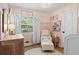 Charming bedroom with pink walls, decorative curtains, and a cozy reading nook at 2703 Carolyn Se Dr, Smyrna, GA 30080