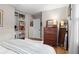Cozy bedroom features built-in closet, wood floors, and a vintage dresser with large mirror at 2703 Carolyn Se Dr, Smyrna, GA 30080