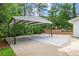 Spacious covered carport with concrete pad and deck in background at 2703 Carolyn Se Dr, Smyrna, GA 30080