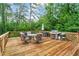 Spacious wooden deck with outdoor seating, grill, and lush green trees surrounding at 2703 Carolyn Se Dr, Smyrna, GA 30080