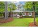 Charming brick home with a well-maintained front yard, mature trees, and inviting front porch at 2703 Carolyn Se Dr, Smyrna, GA 30080
