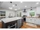 Renovated kitchen with stainless steel appliances, a large island, and adjacent dining space at 2703 Carolyn Se Dr, Smyrna, GA 30080