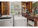 Convenient laundry area featuring modern washer and dryer, storage shelves, and utility sink at 2703 Carolyn Se Dr, Smyrna, GA 30080