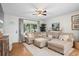 Comfortable living room featuring a sectional sofa, hardwood flooring, and natural light at 2703 Carolyn Se Dr, Smyrna, GA 30080