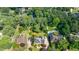 A lush, green aerial view of a property, showing mature trees and manicured lawns at 5004 Haralson Sw Way, Lilburn, GA 30047