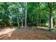 Picturesque backyard with tall trees providing ample shade; ideal for relaxation at 5004 Haralson Sw Way, Lilburn, GA 30047