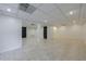 Finished basement featuring neutral tile flooring and white walls, ready for customization at 5004 Haralson Sw Way, Lilburn, GA 30047