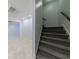 Carpeted stairs lead down to a tiled basement featuring recessed lighting at 5004 Haralson Sw Way, Lilburn, GA 30047
