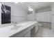 Well-lit bathroom features a dual sink vanity, large mirror, and a shower and toilet at 5004 Haralson Sw Way, Lilburn, GA 30047