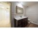 Well-lit bathroom with a single vanity, wainscoting, and a decorative mirror at 5004 Haralson Sw Way, Lilburn, GA 30047