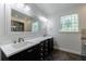 Elegant bathroom with a large vanity with double sinks, decorative window, and soaking tub and shower at 5004 Haralson Sw Way, Lilburn, GA 30047